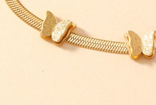 Gold-tone butterfly chain bracelet with repeating butterfly motifs
