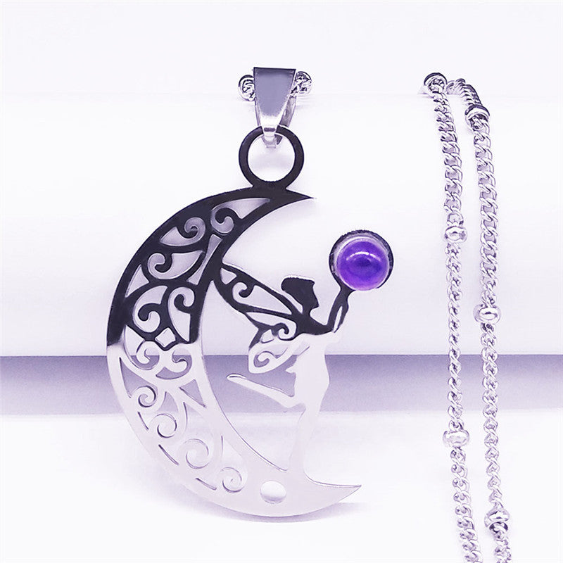 Silver-tone crescent moon and fairy pendant necklace with purple accent, close-up