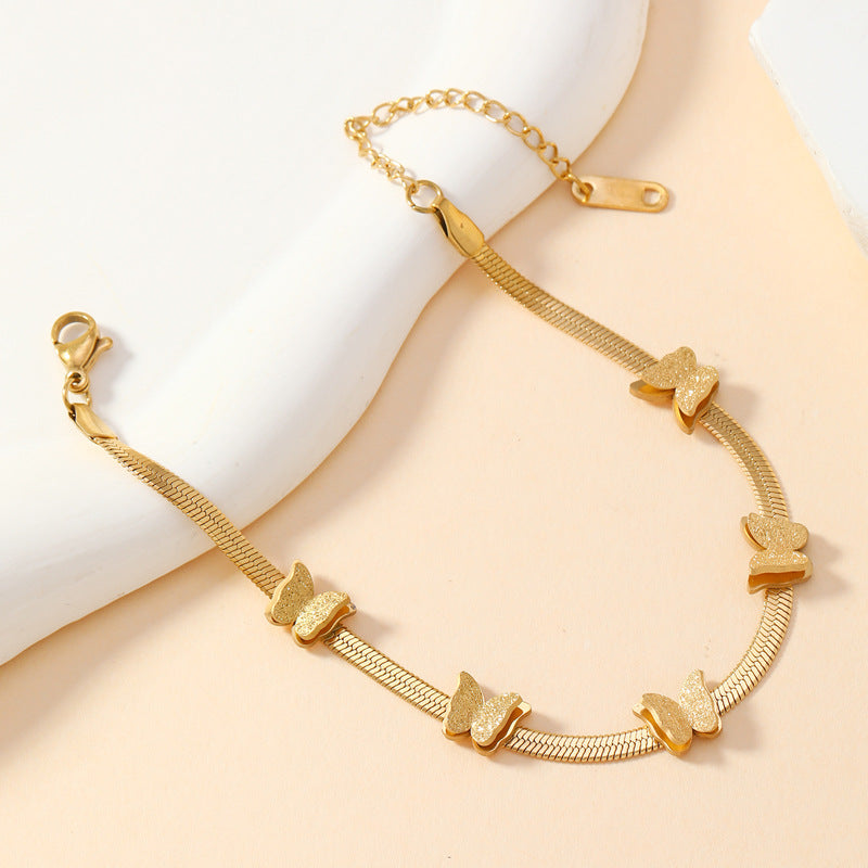 Gold-tone butterfly chain bracelet with repeating butterfly motifs
