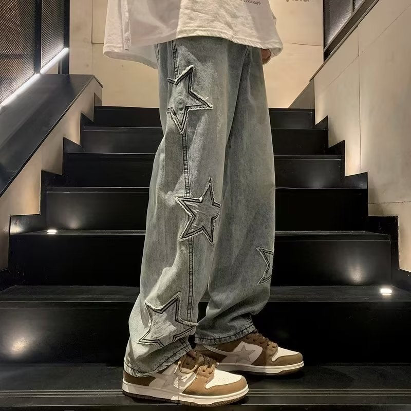 Blue jeans with outlined star motifs along the outer leg