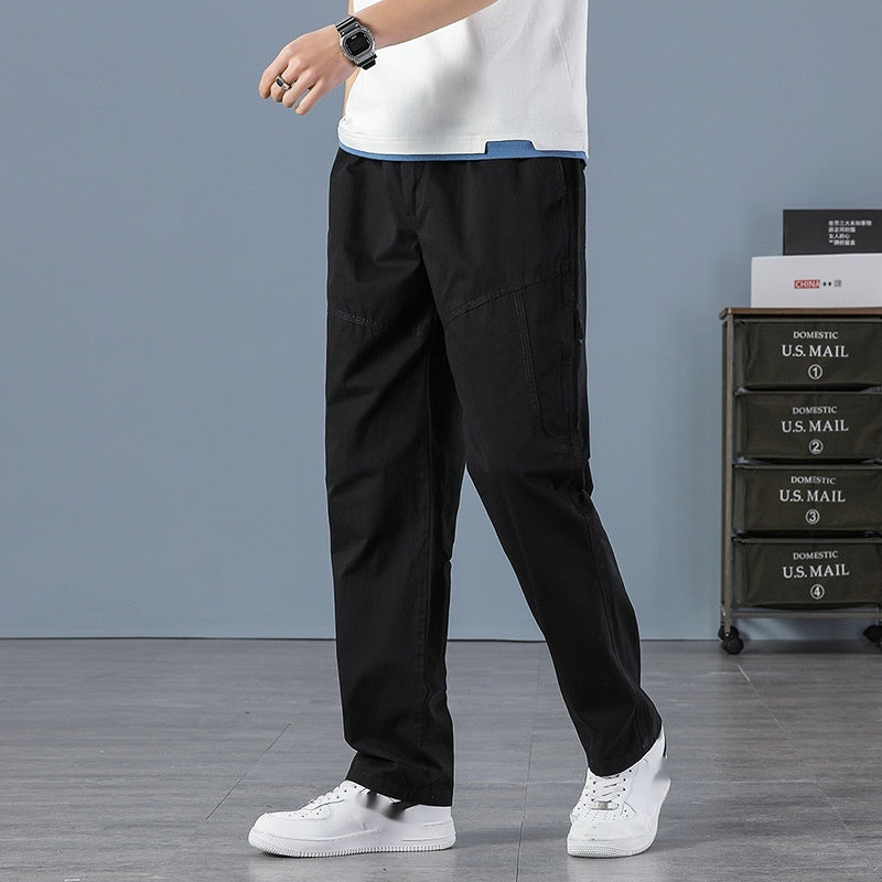 Black loose cargo trousers with an elastic waist, side pockets and diagonal upper-leg seams.