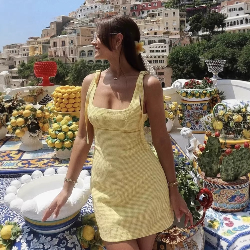 Yellow gingham tie-shoulder mini dress. Supplier product photograph.
