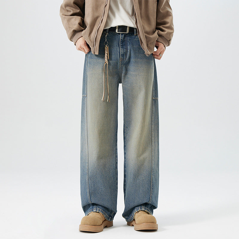 Faded blue-brown wide straight-leg jeans with shaped seam panels.