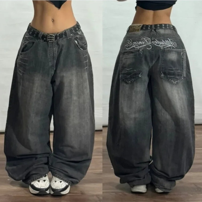 Dark washed wide-leg jeans with decorative white lettering on the rear.