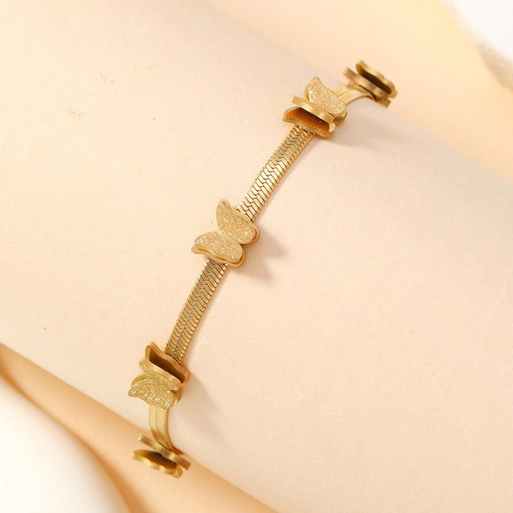 Gold-tone butterfly chain bracelet with repeating butterfly motifs